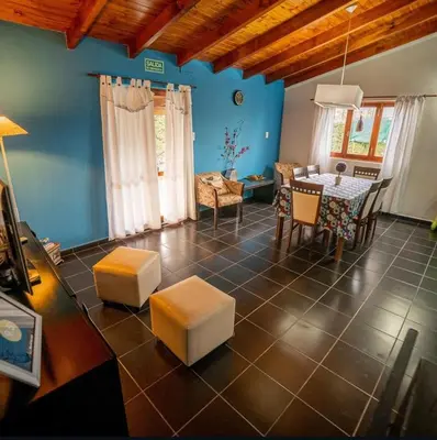 a living room with a table and a dining room at Tierras de Breena in Los Reartes
