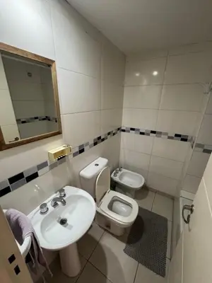 a white bathroom with a sink and a toilet at El cercano a todo in Cordoba