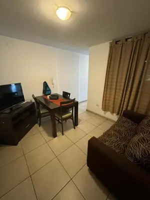 a living room with a table and a television at El cercano a todo in Cordoba