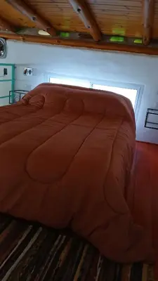 a large brown bed in a room with a window at Pacha es Arte in Villa Ciudad Parque