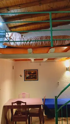 a dining room with a table and two bunk beds at Pacha es Arte in Villa Ciudad Parque
