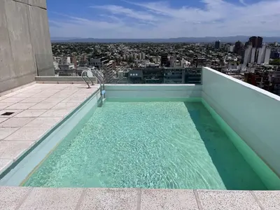 a swimming pool on the roof of a building at Departamento 1 dormitorio con Piscina y Gran Vista en Nueva Cordoba in Cordoba