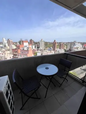 a table and chairs on a balcony with a view at Departamento 1 dormitorio con Piscina y Gran Vista en Nueva Cordoba in Cordoba