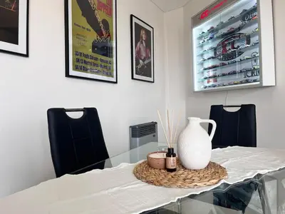 a dining room table with a vase on top of it at Departamento 1 dormitorio con Piscina y Gran Vista en Nueva Cordoba in Cordoba