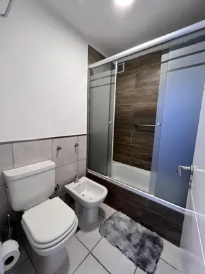 a bathroom with a toilet and a shower and a sink at Departamento 1 dormitorio con Piscina y Gran Vista en Nueva Cordoba in Cordoba