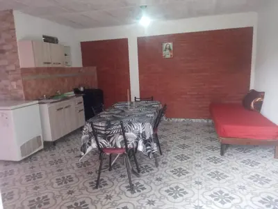 a kitchen with a table and chairs in a room at Depto Villa Soto in Mina Clavero