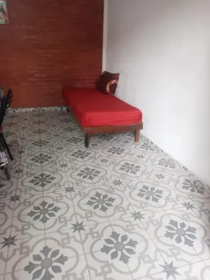 a red bench sitting on top of a floor at Depto Villa Soto in Mina Clavero