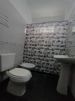 a bathroom with a toilet and a sink at Casa Serrana Punilla in Santa María