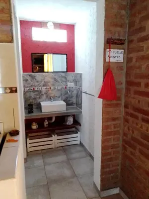 a bathroom with a sink and a mirror at Aguaribay Cabañas in Arroyo de Los Patos