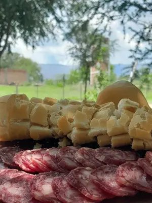 a plate of food with meat and bread on it at Aguaribay Cabañas in Arroyo de Los Patos