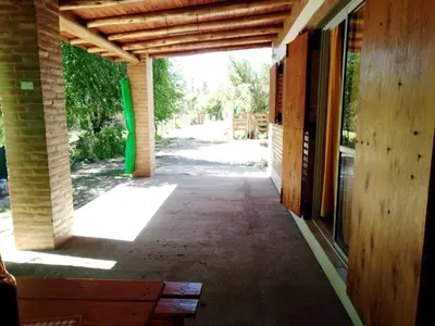 an empty hallway of a building with a wooden ceiling at Aguaribay Cabañas in Arroyo de Los Patos
