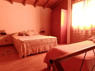 a bedroom with two beds and a window at Aguaribay Cabañas in Arroyo de Los Patos