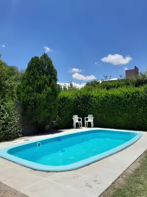 a small swimming pool with two chairs in a yard at Posada L'Agustina in Nono