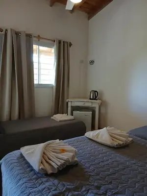a bedroom with two beds with towels on them at Posada L'Agustina in Nono