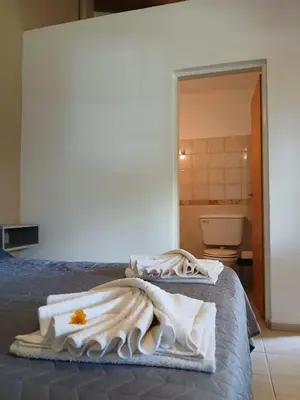 a bedroom with a bed with towels on it at Posada L'Agustina in Nono