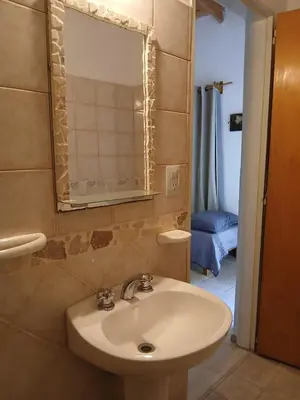a bathroom with a sink and a mirror at Posada L'Agustina in Nono