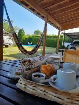 a picnic table with a basket of food and cups at Posada L'Agustina in Nono