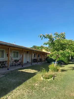 a house with a hammock in the yard at Posada L'Agustina in Nono