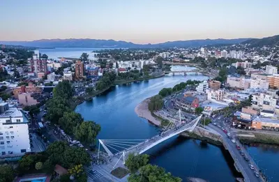 a city with a bridge over a river at Dpto Centro de Carlos Paz - Avellana in Villa Carlos Paz