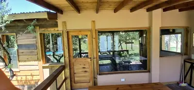 a house with glass doors and a patio at Suspiro Serrano in Villa General Belgrano