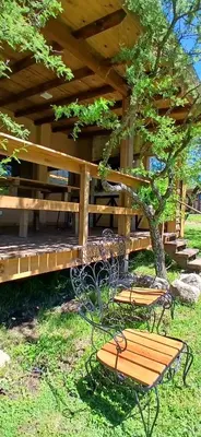 two benches and a table under a wooden deck at Suspiro Serrano in Villa General Belgrano