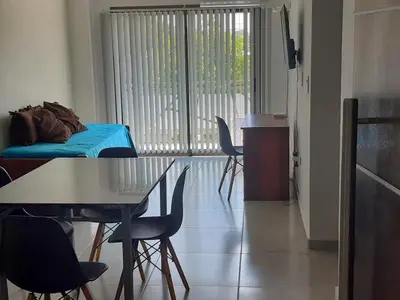 a room with a table and chairs and a bed at Traslasierra Champaquí Deptos in Villa Dolores