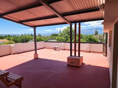 an outdoor patio with a roof with a view at Traslasierra Champaquí Deptos in Villa Dolores