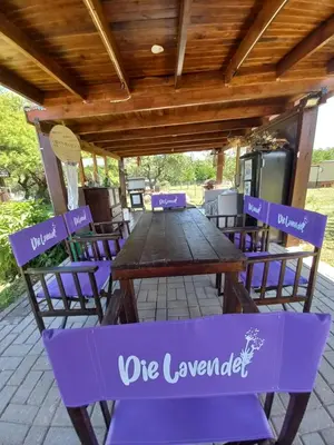 a wooden table and chairs under a wooden roof at R y C Nuestro Lugar in Villa General Belgrano