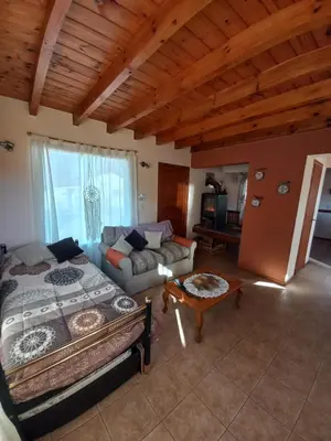 a living room with a bed and a couch at R y C Nuestro Lugar in Villa General Belgrano