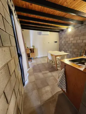 a kitchen and dining room with a table in a room at La Bimba Cabañas en Cabalango in Cavalango