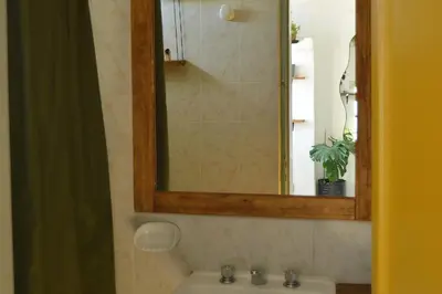 a bathroom with a mirror and a sink at Casa Revol céntrica ideal familias-grupos hasta 12 pax in Cordoba
