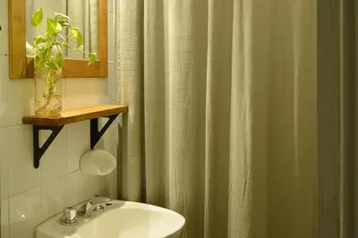 a bathroom with a sink and a shower curtain at Casa Revol céntrica ideal familias-grupos hasta 12 pax in Cordoba
