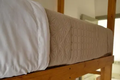 a mattress sitting on top of a wooden bench at Casa Revol céntrica ideal familias-grupos hasta 12 pax in Cordoba
