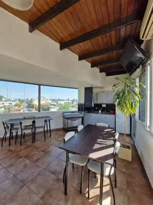 a kitchen and dining room with tables and chairs at Miralejos I Carlos Paz in Villa Carlos Paz