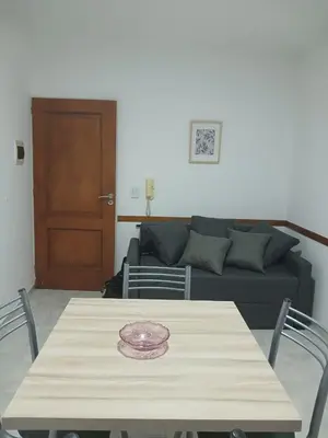 a living room with a table and a couch at Miralejos I Carlos Paz in Villa Carlos Paz