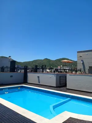 a swimming pool on the roof of a building at Miralejos I Carlos Paz in Villa Carlos Paz