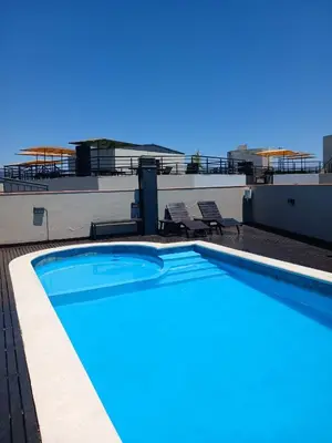 a swimming pool on the roof of a building at Miralejos I Carlos Paz in Villa Carlos Paz