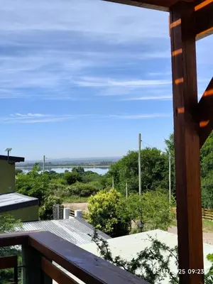 a view of the ocean from a house balcony at Cabaña Ali in Villa Rumipal
