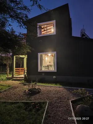 a black house with a window on the side of it at Cabaña Ali in Villa Rumipal