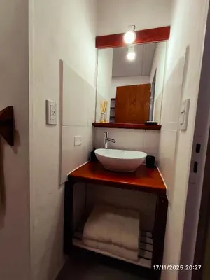 a bathroom with a sink and a mirror at Cabaña Ali in Villa Rumipal