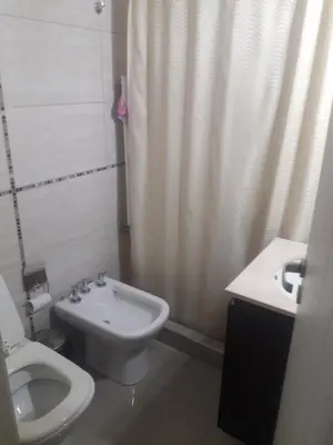 a bathroom with a toilet and a shower and a sink at Terraza Carlos Paz in Villa Carlos Paz