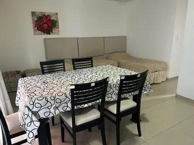 a dining room table with chairs and a white and black table cloth at Terraza Carlos Paz in Villa Carlos Paz