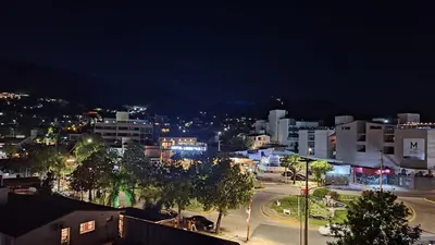 a city lit up at night with buildings and trees at Terraza Carlos Paz in Villa Carlos Paz