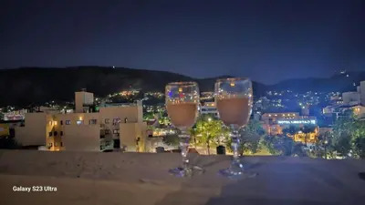 two glasses of wine sitting on top of a ledge at Terraza Carlos Paz in Villa Carlos Paz