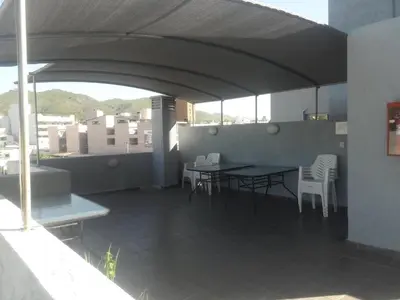 a patio with a table and chairs on a balcony at Terraza Carlos Paz in Villa Carlos Paz
