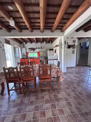a kitchen and dining room with a table and chairs at Las Tole - Potrero de Garay in La Estancia