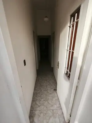 an empty hallway in a building with a window at Dpto Villa Carlos Paz max 5 personas in Villa Carlos Paz