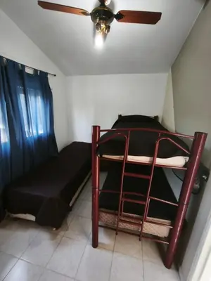 a bedroom with a bunk bed and a ceiling fan at Dpto Villa Carlos Paz max 5 personas in Villa Carlos Paz
