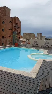 a large blue swimming pool on top of a building at Sam Mira 1 in Villa Carlos Paz