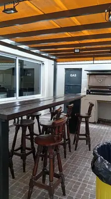 a large wooden table and chairs in a room at Sam Mira 1 in Villa Carlos Paz